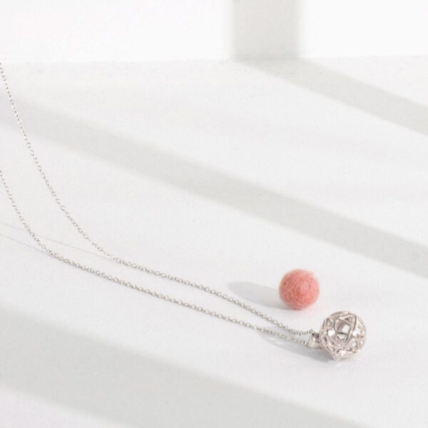 Lifestyle shot of our 925 silver aromatherapy necklace with single wool-felt diffuser ball