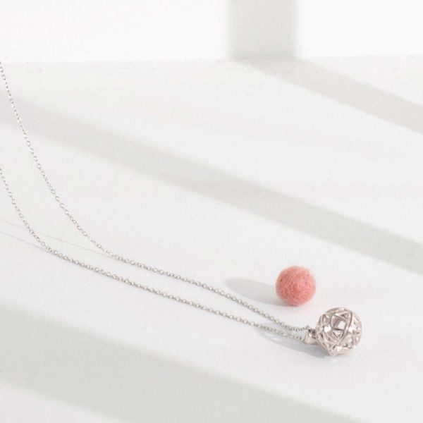 Lifestyle shot of our 925 silver aromatherapy necklace with single wool-felt diffuser ball