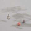 A closeup of our Eternal Sunshine 925 sterling silver aromatherapy necklace with wool-felt balls